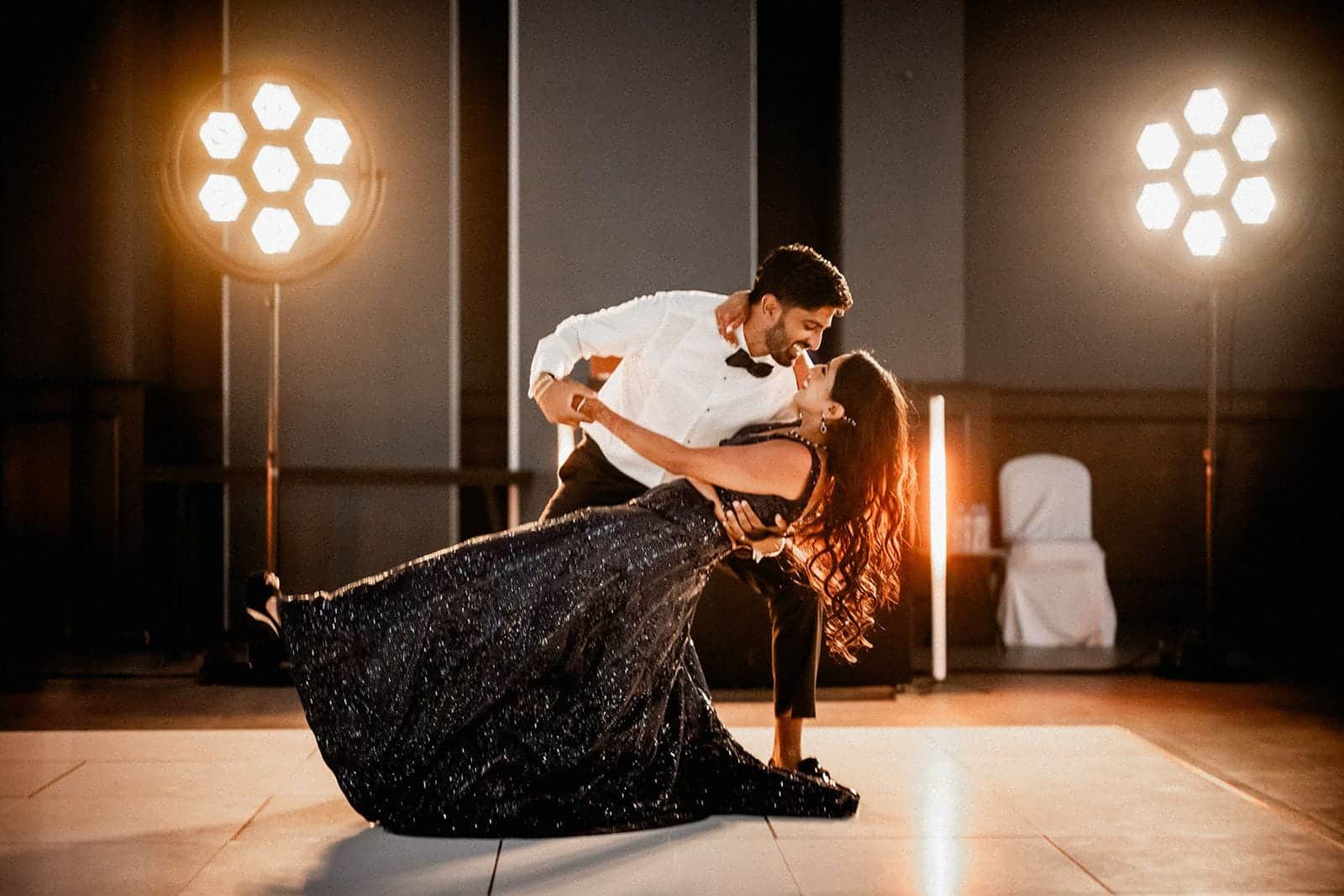 Couple dancing on a white dance floor between two Portman P1 Evo lights