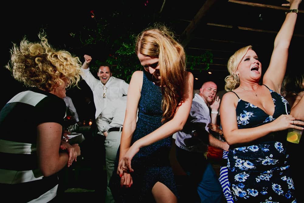 Wedding guests dancing under a pergola at a Mykonos wedding party